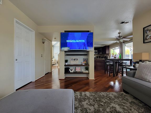 Second Living room, TV mount included along with floating shelves/ cable hidden in wall accessories. Direct view to 1st living room/kitchen. Garage door access on the left