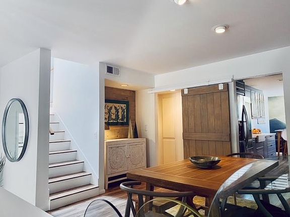 dining room, stairs to Master Bedroom, kitchen, and sliding door to ensuite / second bedroom to the left