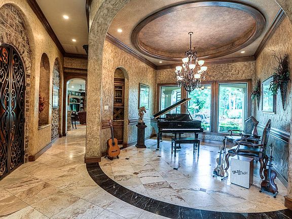 Formal dining with beautiful Travertine floors and professional faux paint with great view of the massive back yard.