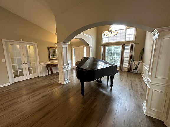 Living room looking towards the front sitting room & foyer. Double doors on the left going to right wing hallway