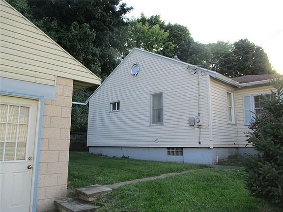 Left side of the property.  Basement has block windows.