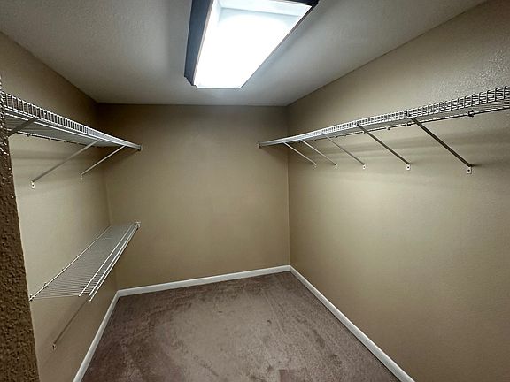 Primary bedroom walk-in closet with ample storage.