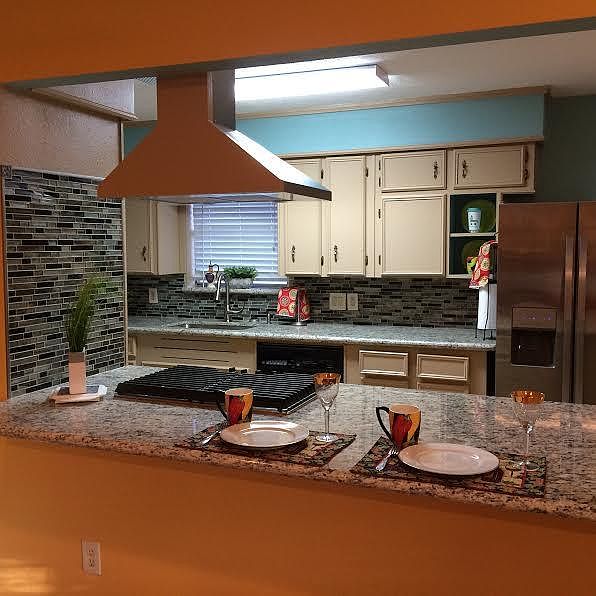 Cooper colored paint is now white. Enjoy bar for easy entertaining and enjoying family. Gas stove.