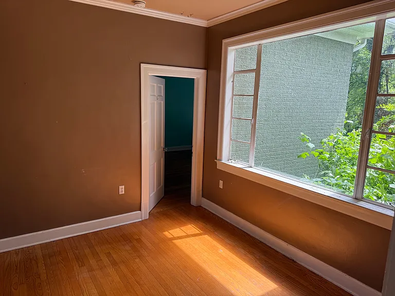 A smaller room that leads into two bedrooms.
