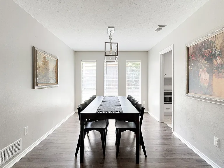 Dining space with LVP wood-type flooring and a chandelier