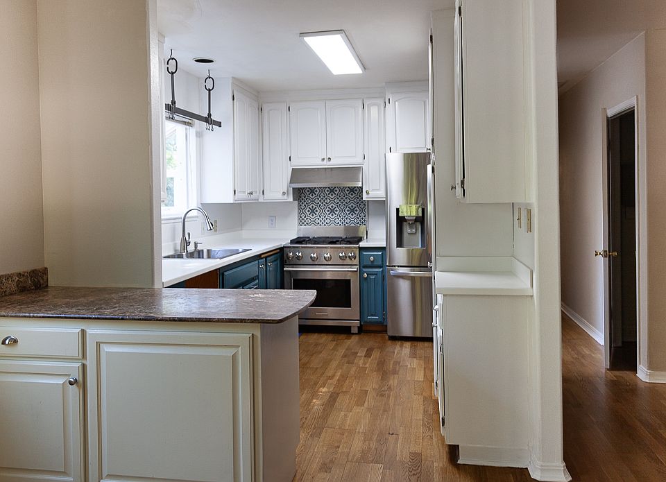 Kitchen with high end appliances, new paint on cabinets, new countertop, new sink.