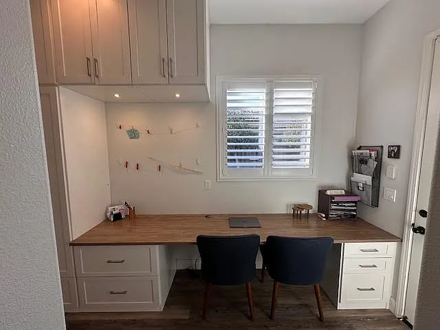 Office with built-in desk and cabintry