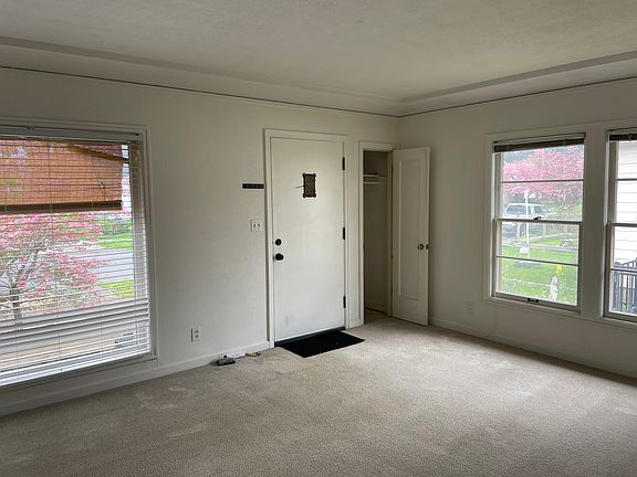 Living room, front door and coat closet with mail slot