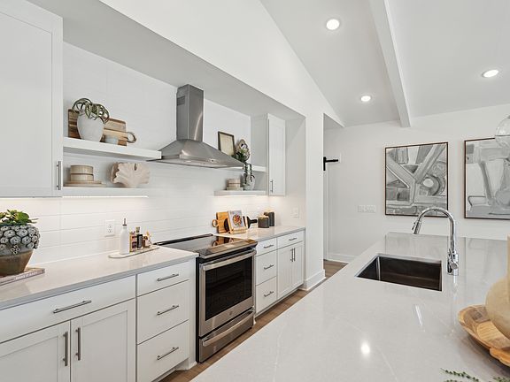 Kitchen with stainless steel vent hood