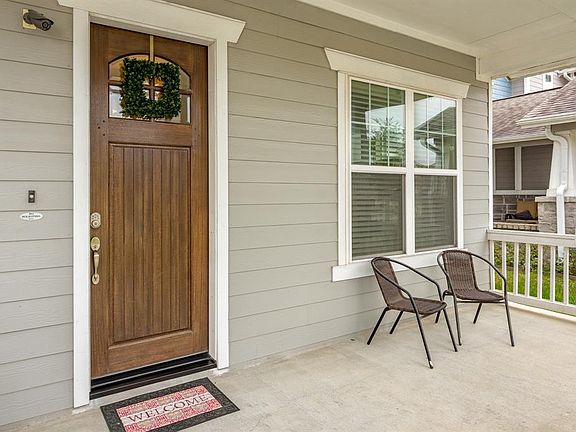 Expansive covered front porch is great for relaxing and chatting with your new neighbors!