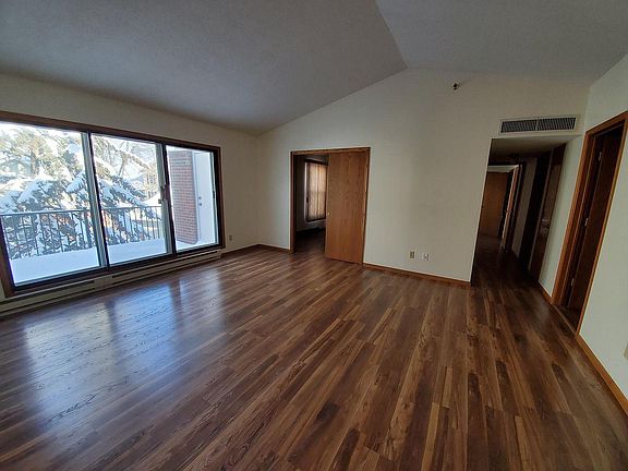 Vaulted ceiling and wood floor living room