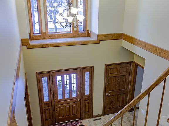 Welcome your guests in this beautiful main entrance with oak six panel doors and glass french doors leading to den. Foyer has gently curving staircase. Windows have blinds with remote control.