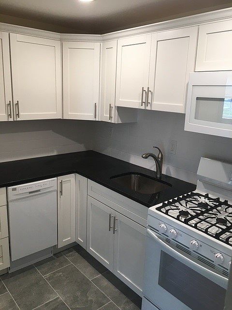 Kitchen with gas range and microwave