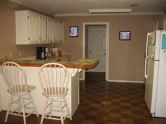 Kitchen with numerous cabinets, wood parquet floor and large pantry!