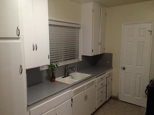 Kitchen includes refrigerator and range.