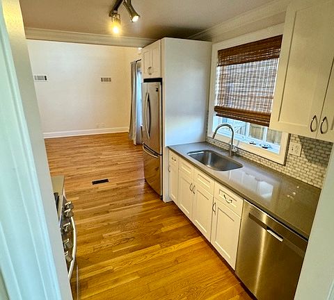 Galley Kitchen with stainless steel appliances (fridge/dishwasher)