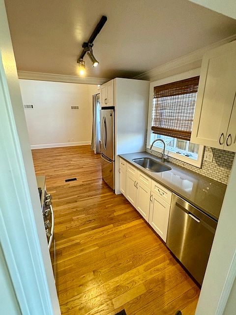 Galley Kitchen with stainless steel appliances (fridge/dishwasher)
