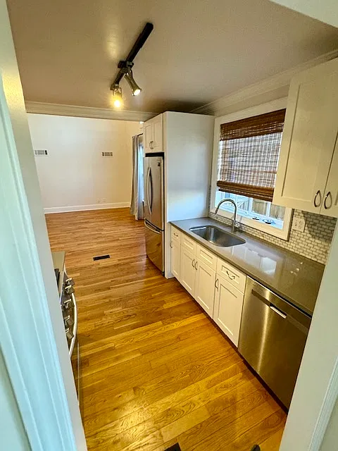 Galley Kitchen with stainless steel appliances (fridge/dishwasher)