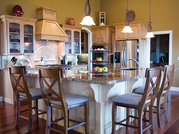 Island with crushed, black granite sink and granite slab counter.