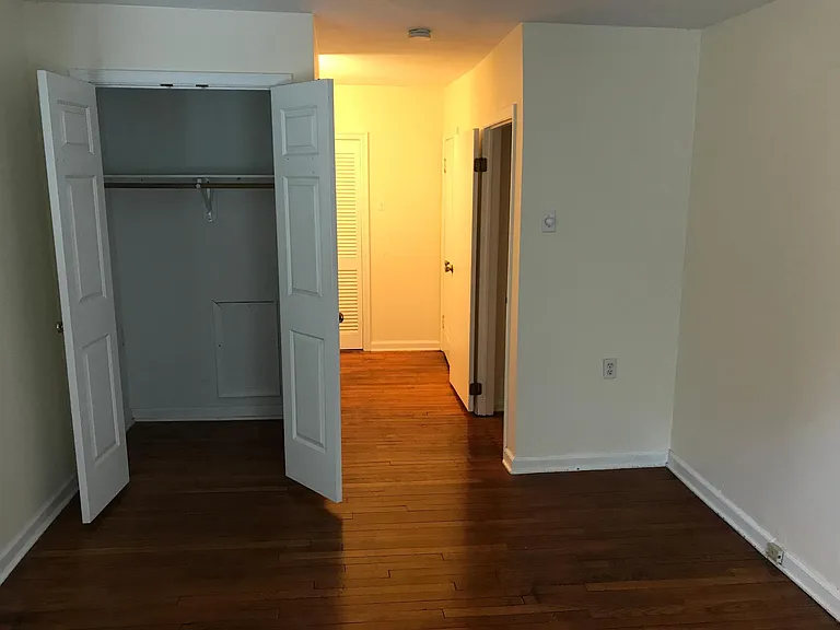 Bedroom w/ closet. View to changing area, w/d closet and bathroom.