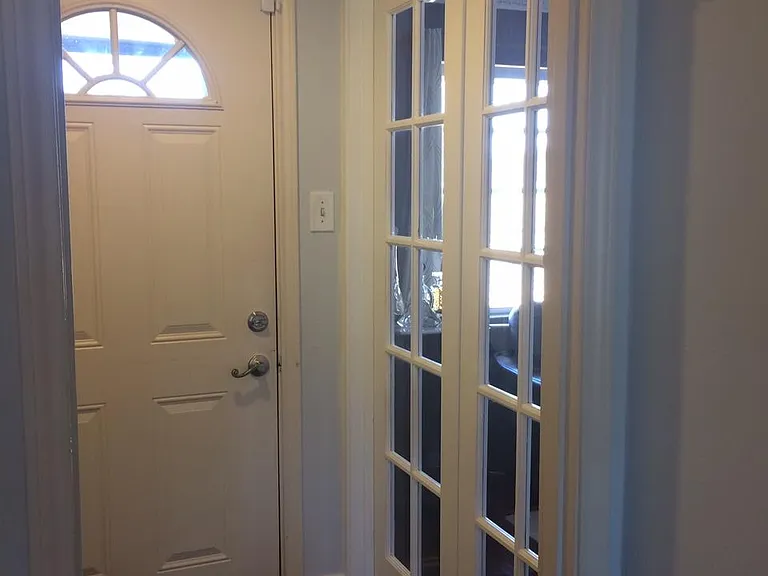 Main entrance - French door leads to library