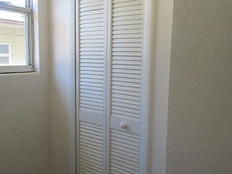 Louvered doors on bedroom closet.