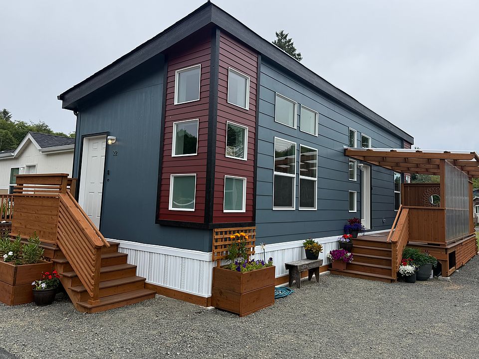 Exterior with enclosed patio and gravel driveway