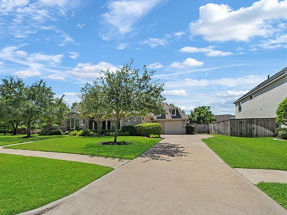 The long driveway widens as it leads to the two car garage providing plenty of off street parking for homeowners and guests.
