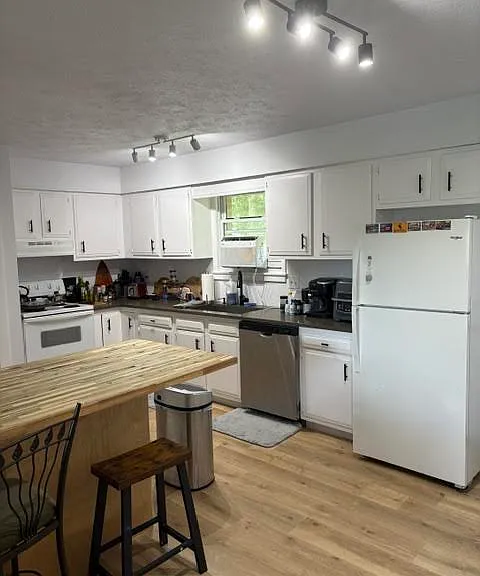 Gorgeous kitchen with Quartz Countertops, Butcher Block Island and lots of Cabinet Space.
