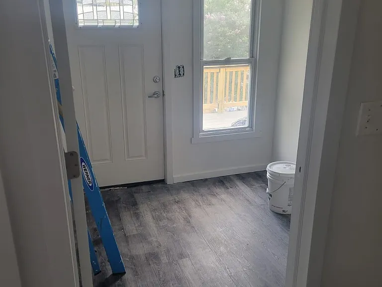 Mudroom in between kitchen and rear entrance.