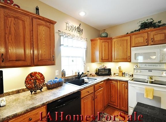 The window above the large kitchen sink gives you a full view of the pool area and wooded backyard.