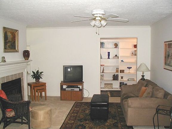 Living Room with fireplace and ceiling fan. 