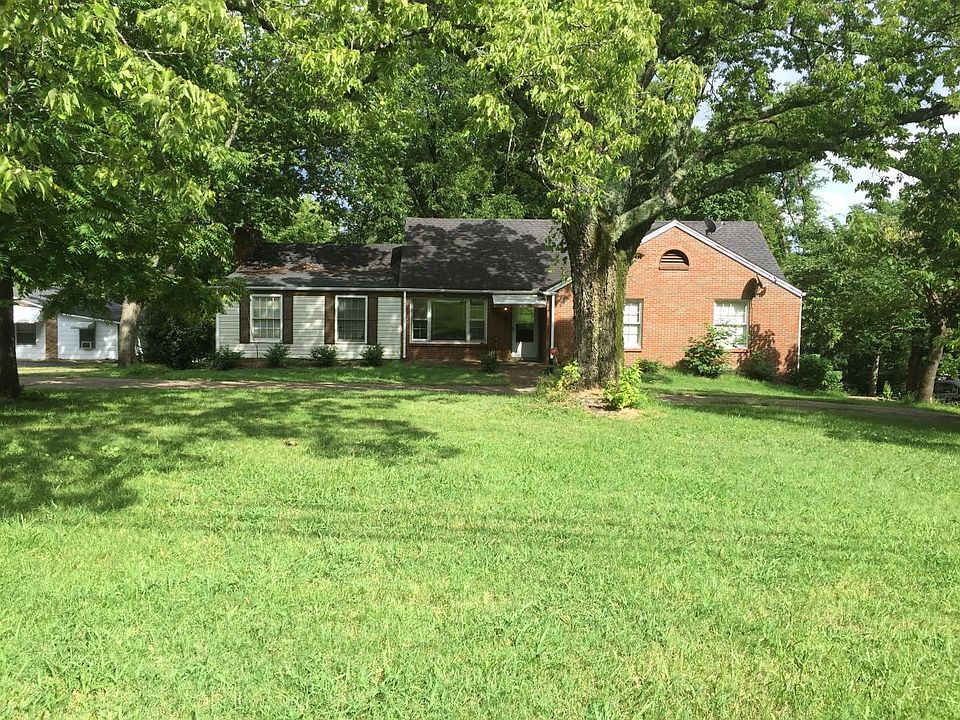 large yard with mature trees