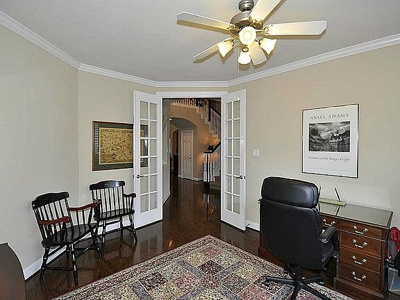 Functional study with French door entrance. Spacious work area & ceiling fan.
