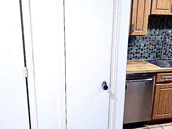 Entryway closet and part of kitchen