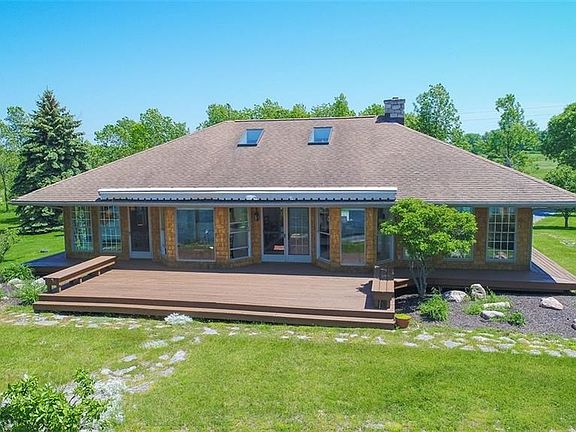 Beautiful year round home at the mouth of the St Lawrence on Lake Ontario with 600+ ft of Waterfront on 5+ acres