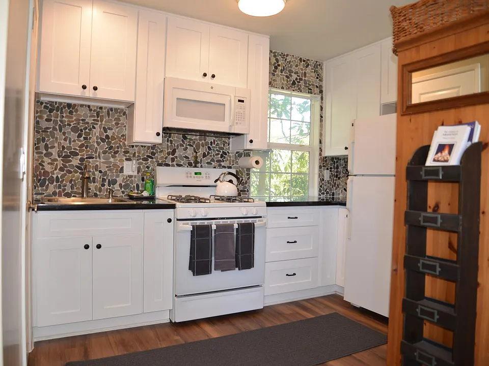 Kitchen with full size fridge, stove, microwave, toaster, coffee maker and all cooking utensils.