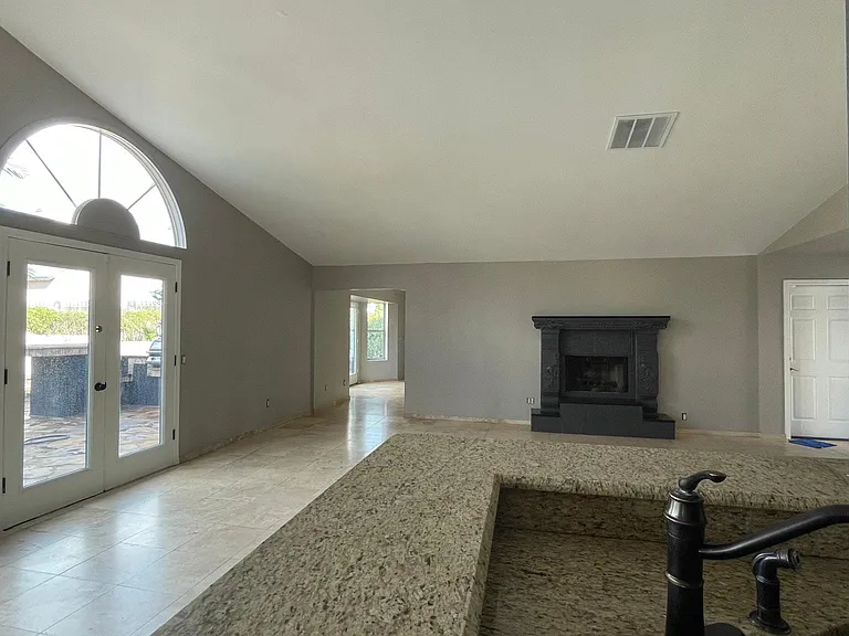 UNFURNISHED. View of the kitchen to dining and living room, office at the background.