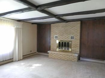 Spacious living room offers brick wood burning fireplace