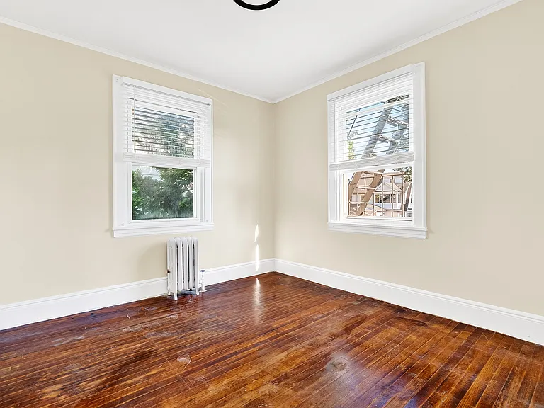 Bedroom with hardwood floors.