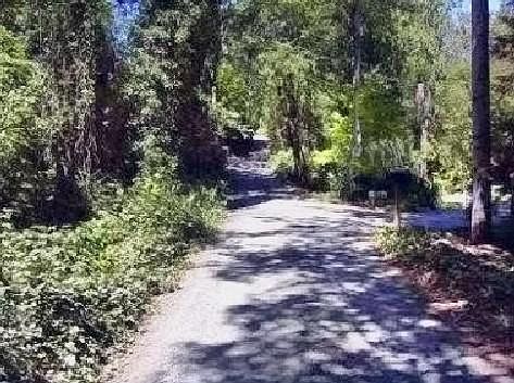 Back entry to property passes the pond. Two acre property i