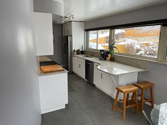 Kitchen windows overlook the huge and beautiful backyard.