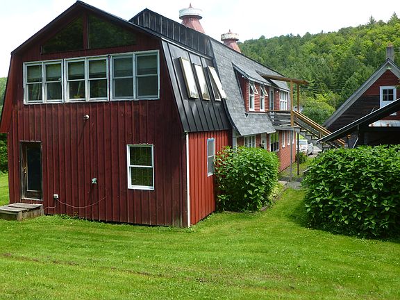 Rear yard with grass and horseshoe pit