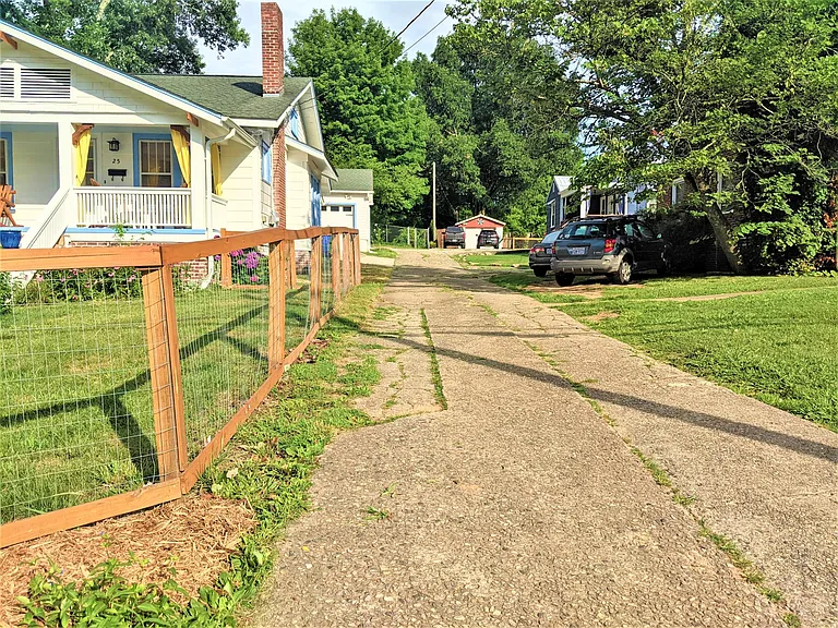 Paved alley on the side of the house is shared with neighbors and will be how you access parking.