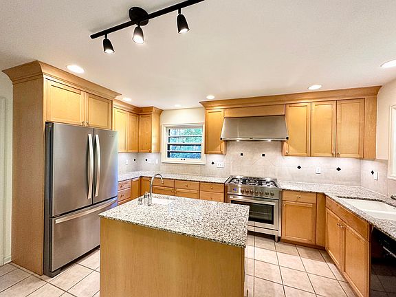 Kitchen with French-door refrigerator, 5 burner gas stove, dishwasher, island, second sink, and breakfast nook