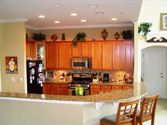 Kitchen with granite countertops,stailess appliaces and ceramic backsplash