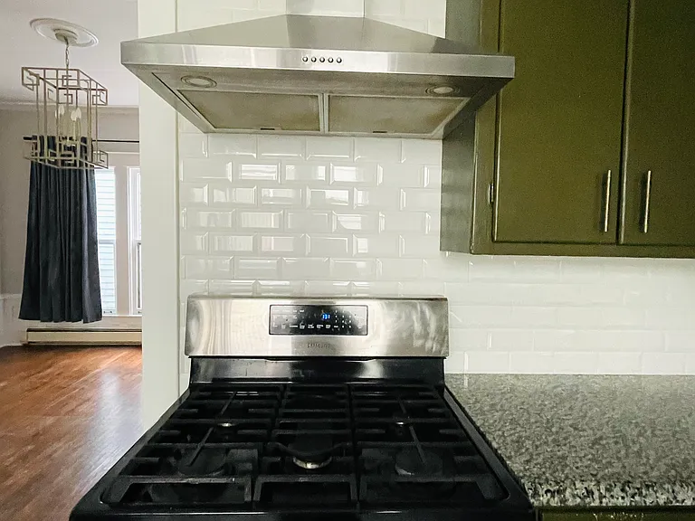 Gas stove and vented hood. Kitchen has a secondary mechanical vent by the windows for extra ventilation while cooking.