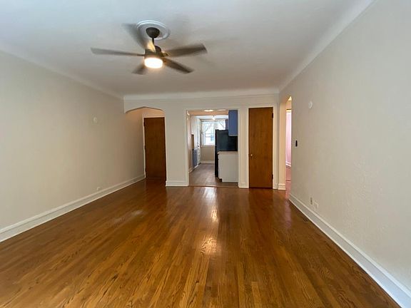 Main room 18' x 14'. View of kitchen. Notice ceiling fan with light.