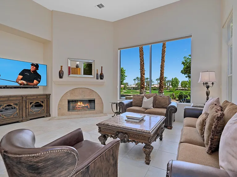 Living room with beautiful fireplace and golf course views