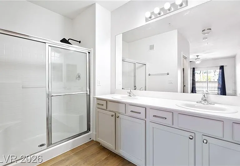 Primary bathroom with double vanities and shower
